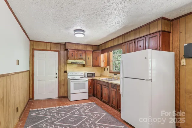 a kitchen with a refrigerator a stove top oven a sink and dishwasher