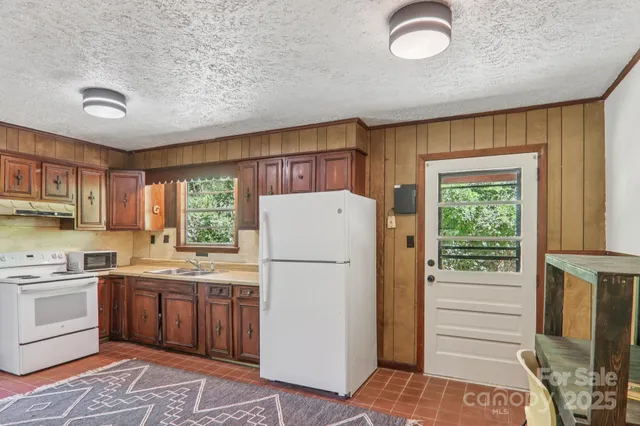 a kitchen with a refrigerator sink and cabinets