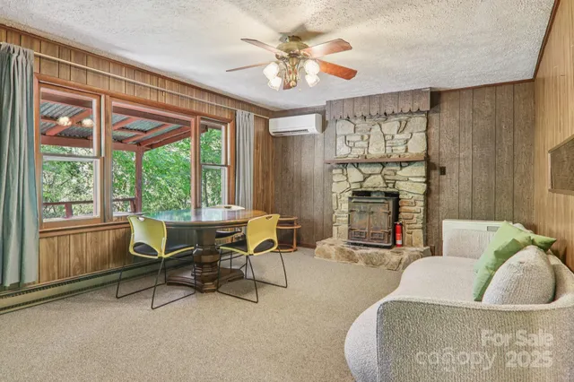 a living room with furniture and a floor to ceiling window