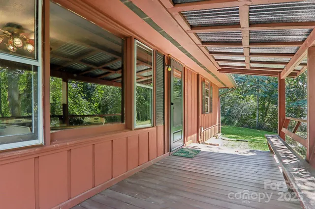 a view of a porch with wooden floor and outdoor space