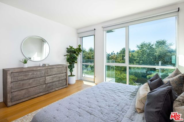 a living room with a bed closet and a large window