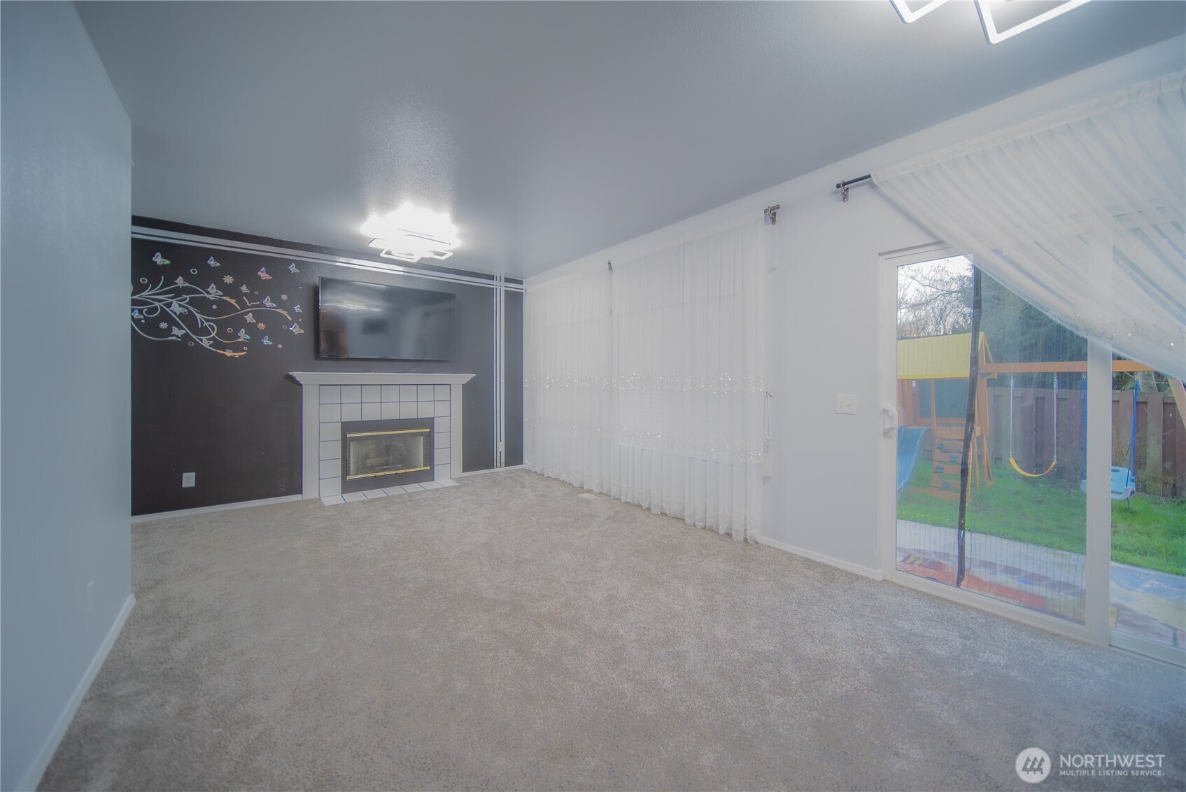 5615 South 233rd Street Kent, WA 98032 - Photo 8 of 24 a view of empty room with window and fireplace