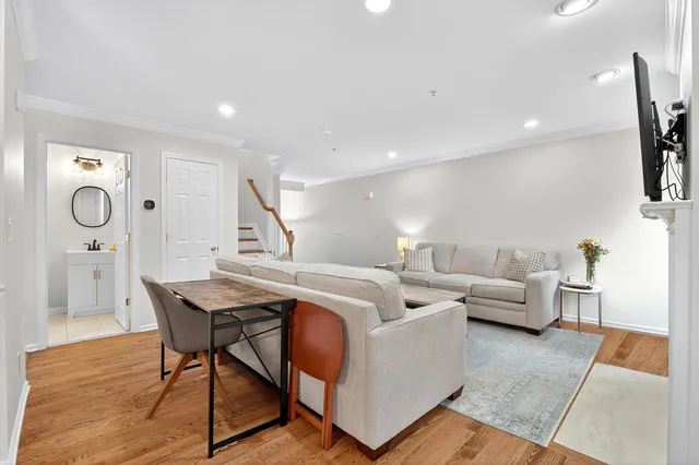a living room with furniture and a clock