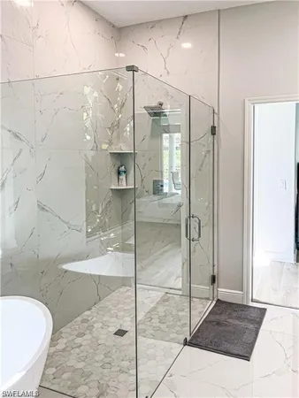 a bathroom with a granite countertop shower mirror and a sink