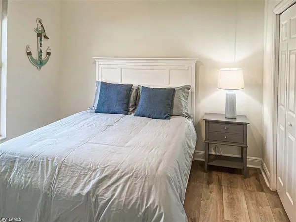 a bedroom with a bed and a night stand