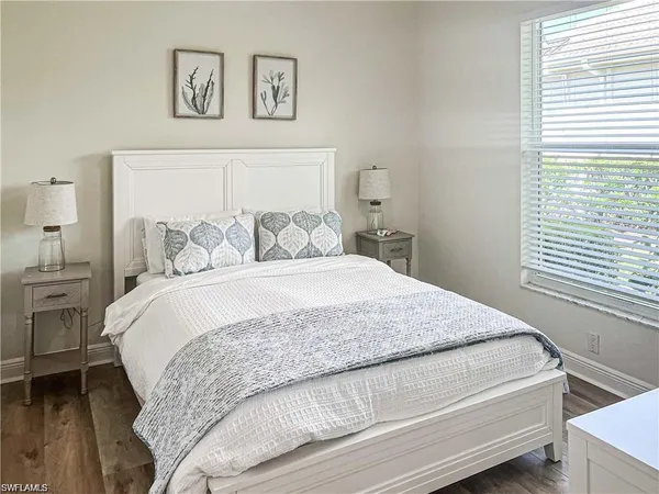 a bedroom with a bed and a night stand