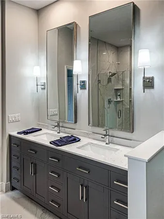 a bathroom with double vanity sinks and a mirror