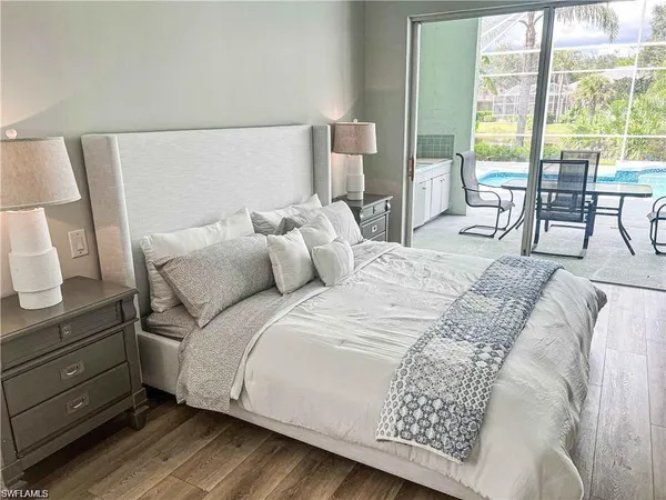 a large bed sitting in a bedroom next to a window