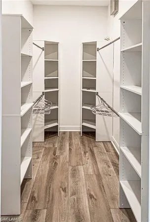 a view of walk in closet with empty racks