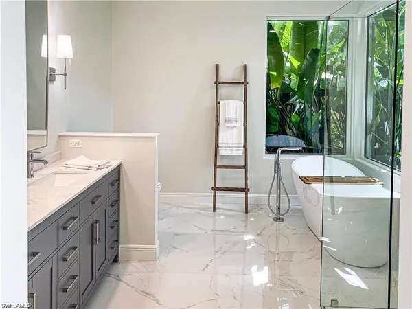 a spacious bathroom with a double vanity sink and a mirror