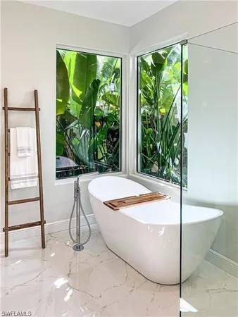 a room with pool table and windows