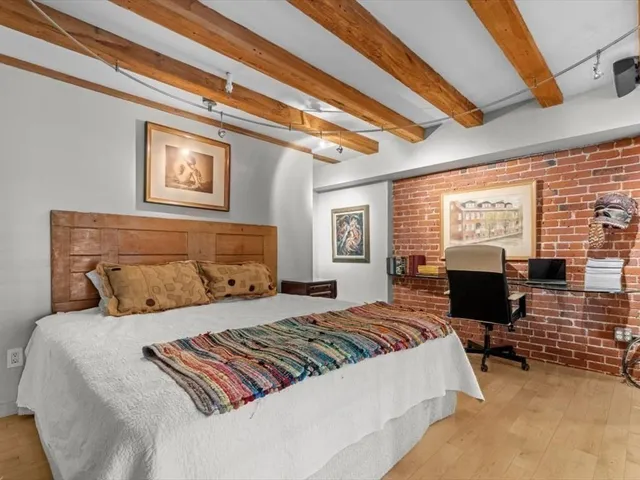 a bedroom with a bed and lamp with window