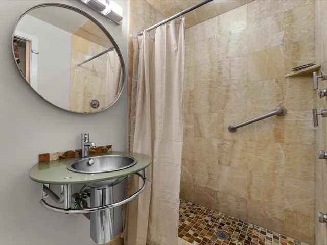 a room with a sink and chandelier