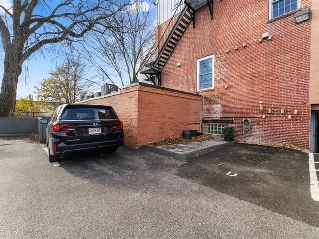 a car parked in front of a brick house