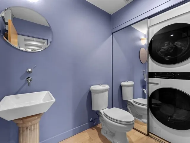 a bathroom with a toilet a sink and a mirror