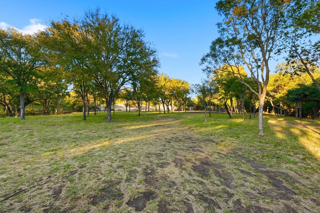 2401 Bear Creek Road Aledo, TX 76008 - Photo 30 of 37 View of green lawn with view of wooded area