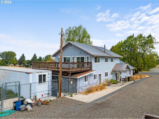 an aerial view of a house with a yard and potted plants