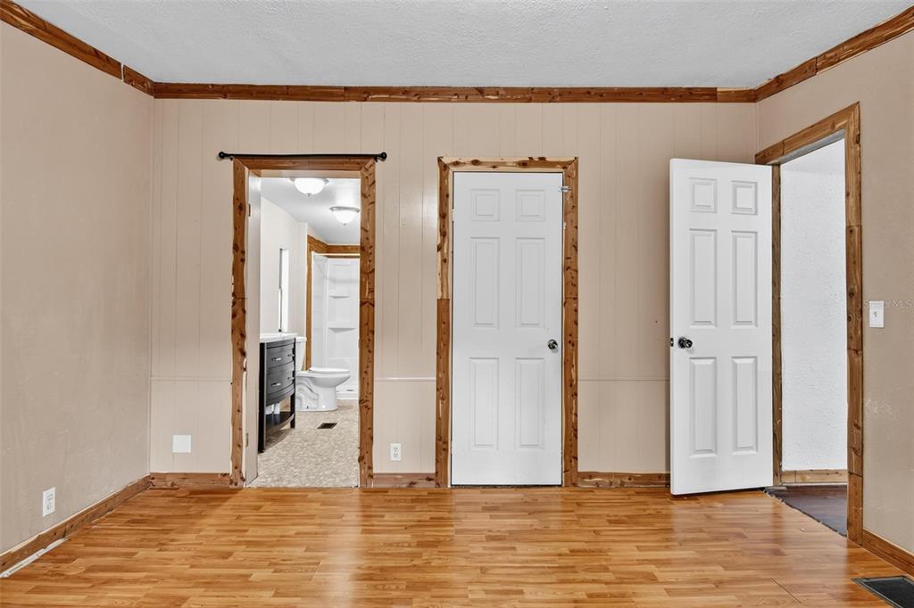156 Kingfish Road Pomona Park, FL 32181 - Photo 20 of 55 a view of a livingroom with wooden floor and a bathroom space