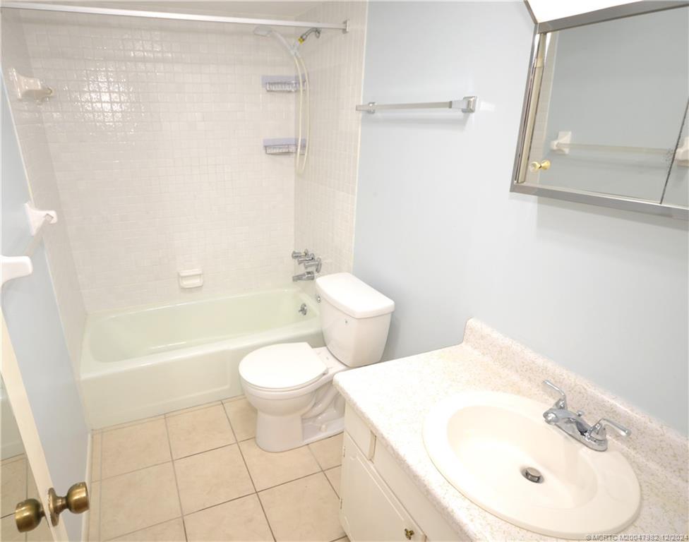 1900 South Kanner Highway, Unit 7205 Stuart, FL 34994 - Photo 11 of 25 a bathroom with a toilet a sink and bathtub