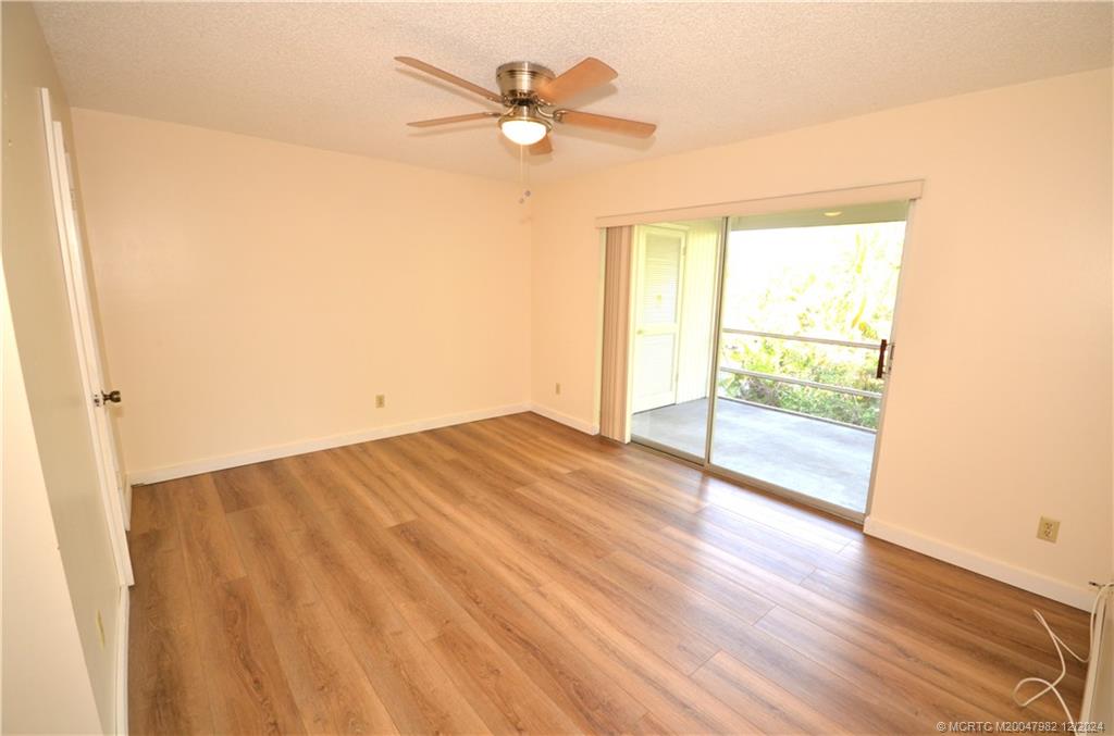 1900 South Kanner Highway, Unit 7205 Stuart, FL 34994 - Photo 13 of 25 wooden floor in an empty room with a window