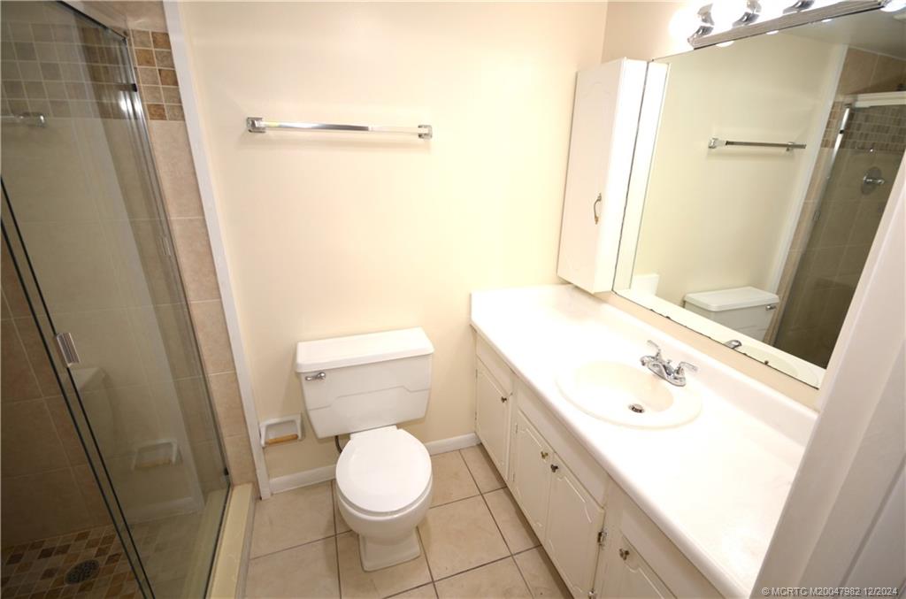 1900 South Kanner Highway, Unit 7205 Stuart, FL 34994 - Photo 15 of 25 a bathroom with a sink a toilet a mirror and shower
