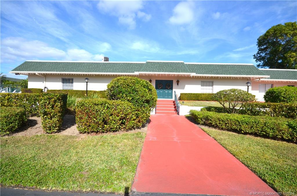 1900 South Kanner Highway, Unit 7205 Stuart, FL 34994 - Photo 23 of 25 a view of a garden with a building in the background