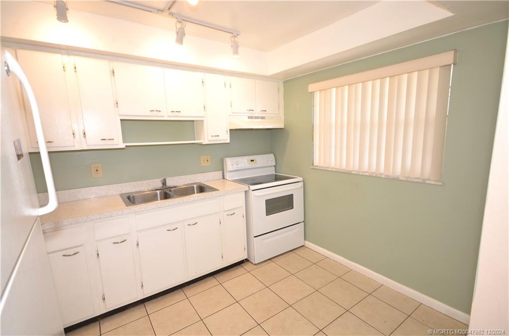 1900 South Kanner Highway, Unit 7205 Stuart, FL 34994 - Photo 3 of 25 a kitchen with a sink cabinets and window