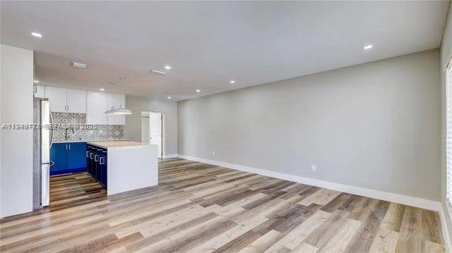 1050 Southwest 11th Street, Unit 1052 Miami, FL 33129 - Photo 3 of 10 a view of kitchen with kitchen island wooden cabinets and stainless steel appliances