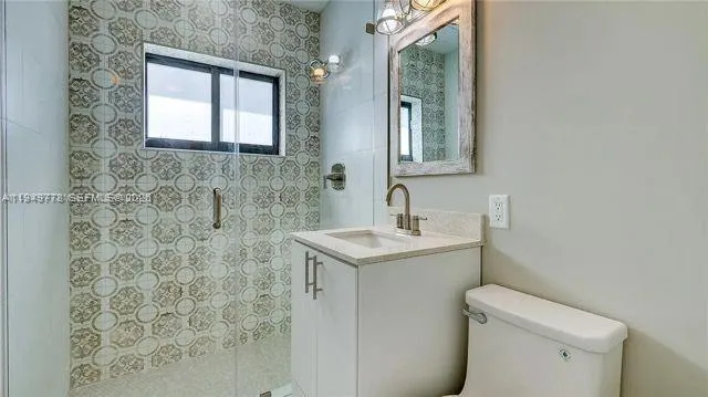 a bathroom with a sink toilet and mirror