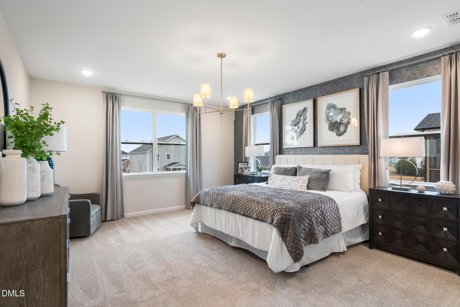 385 Denali Drive Angier, NC 27501 - Photo 14 of 19 a spacious bedroom with a large bed and a chandelier