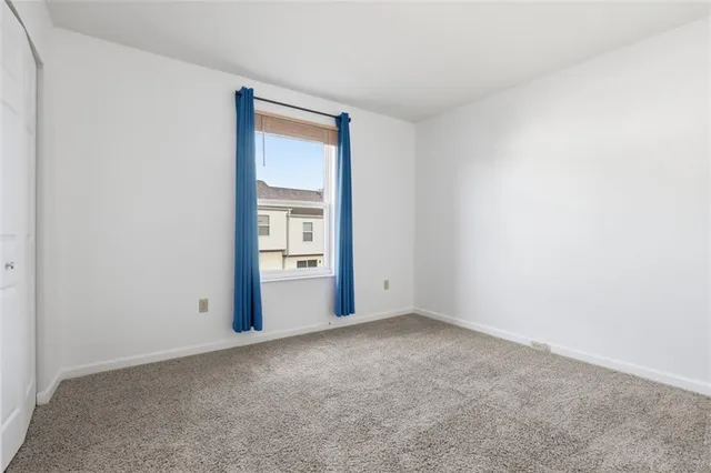 a view of an empty room and closet area