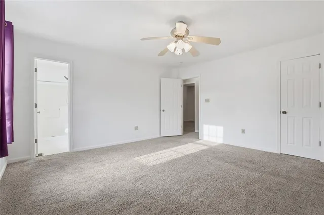 a view of an empty room with a fan
