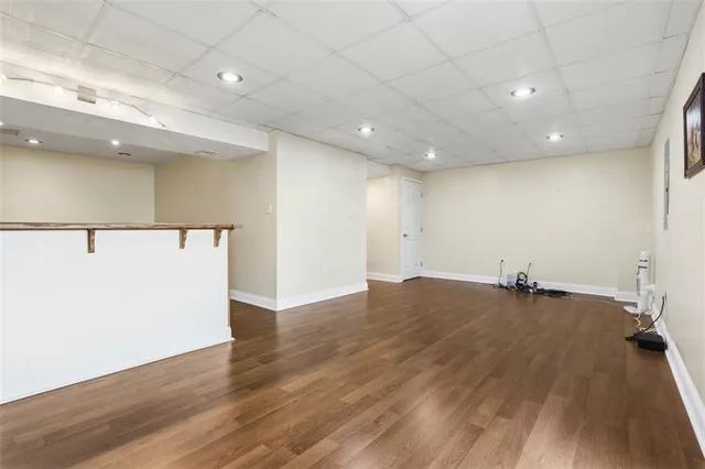 a view of a room with wooden floor