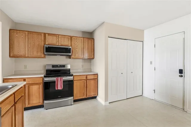 a kitchen with stainless steel appliances granite countertop a stove top oven a sink and dishwasher