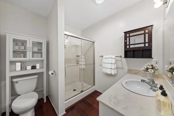 a bathroom with a toilet a sink and shower