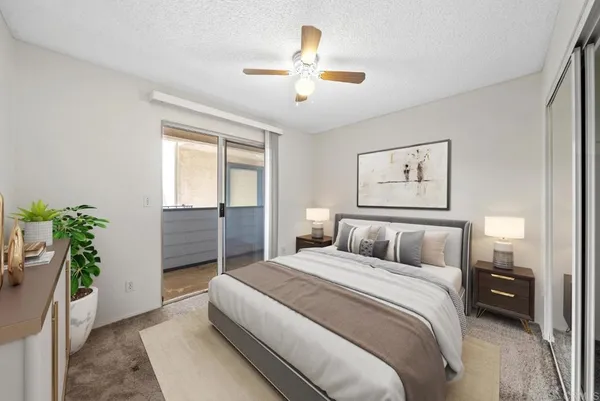 a bedroom with a large bed and a chandelier