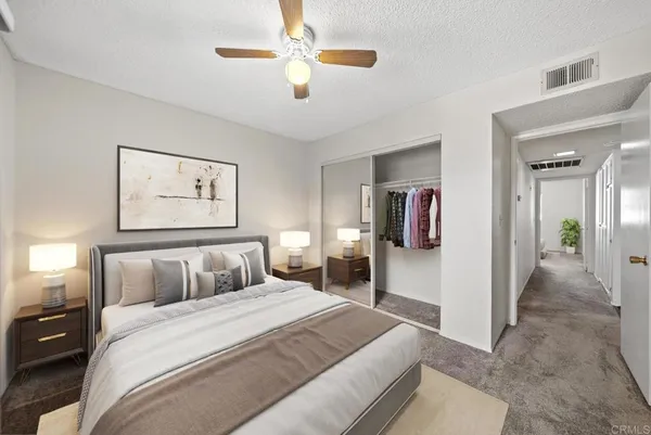 a bedroom with a large bed and a chandelier