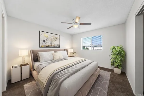 a bedroom with a bed and a potted plant