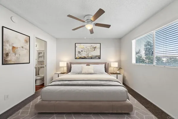 a bedroom with a large bed and a window