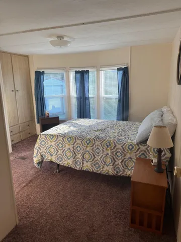 a bedroom with a bed and window