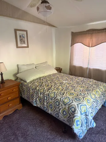 a bedroom with a bed and a mirror