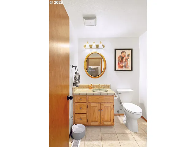 a bathroom with a toilet a sink and a mirror