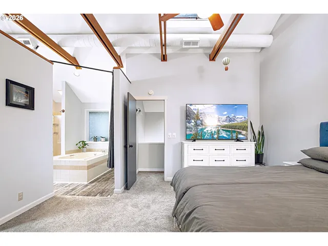 a view of a bedroom with furniture and windows