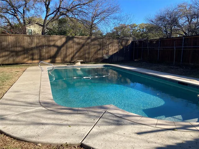a view of a swimming pool with a yard