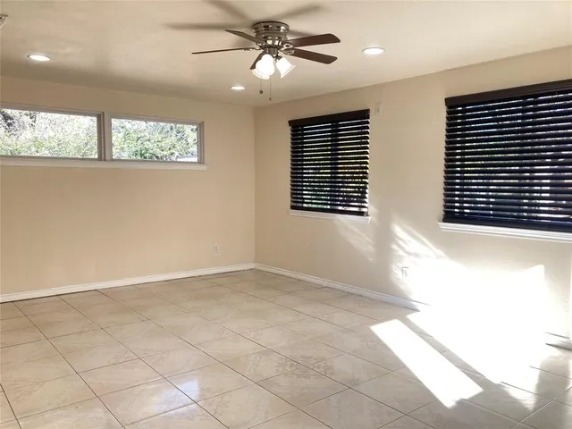 a bathroom with a granite countertop sink a toilet and mirror