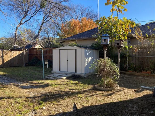 a view of a yard with large trees