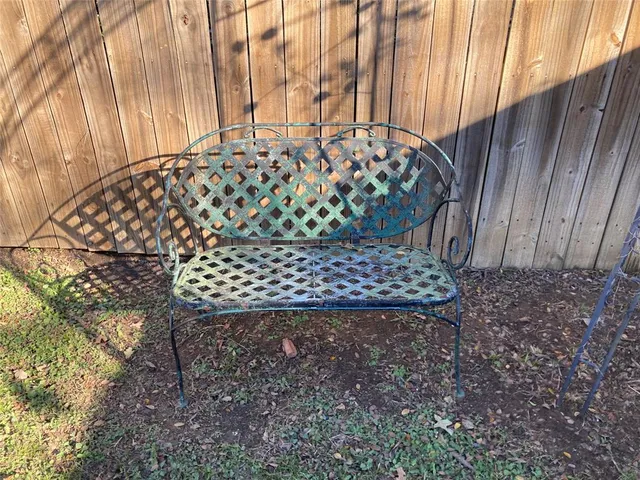 a view of a backyard with a tub and wooden fence