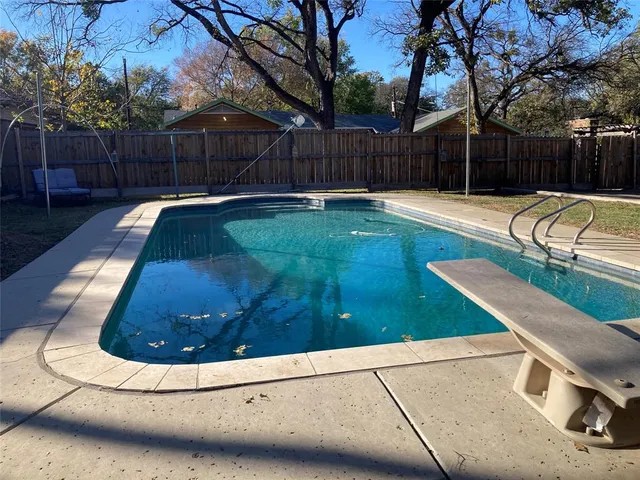 a view of a house with yard and sitting area