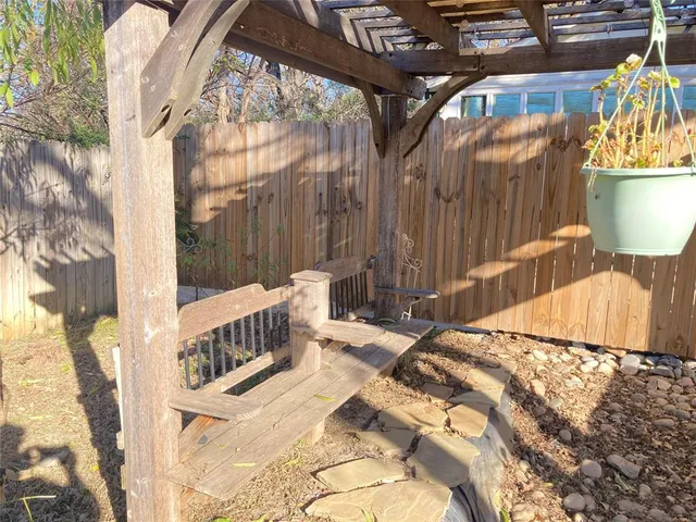a view of a bench in a backyard