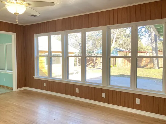 wooden floor in an empty room with a window